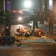 Motorcycles and debris lies on the pavement after the explosion.